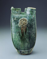 Green-glazed ewer in the shape of a leather pouch