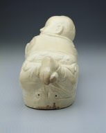 Pillow in the shape of a recumbent child with white glaze