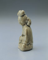 Figurine of a young girl in yellowish-green glaze