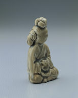 Figurine of a young girl in yellowish-green glaze