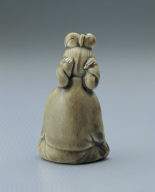 Figurine of a young girl in yellowish-green glaze