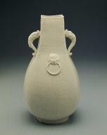 Squarish ewer with applied mask and dragon shaped handles in white glaze