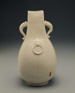 Squarish ewer with applied mask and dragon shaped handles in white glaze