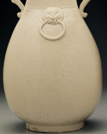 Squarish ewer with applied mask and dragon shaped handles in white glaze