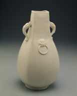 Squarish ewer with applied mask and dragon shaped handles in white glaze