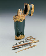 Green stone box contains pencil, scissor, etc.