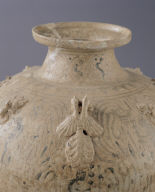 Covered jar in celadon glaze with underglaze painting of winged figure