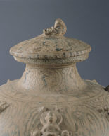 Covered jar in celadon glaze with underglaze painting of winged figure