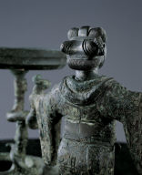 Bronze lamp with support of silver-headed human figure