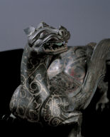 Bronze winged mythical animal inlaid with silver