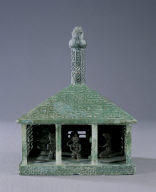 Bronze house with musicians