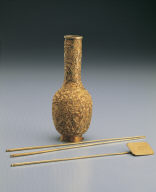 Gold vase, chopsticks, and shovel