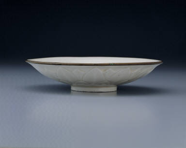 Dish with carved lotus petals and incised decor in white glaze