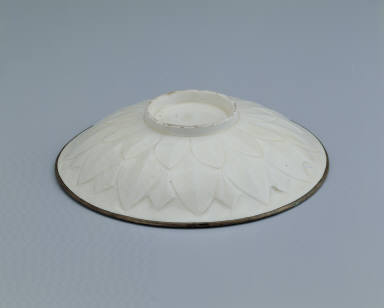 Dish with carved lotus petals and incised decor in white glaze