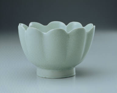 Warming bowl in the shaped of a flower with light bluish-green glaze