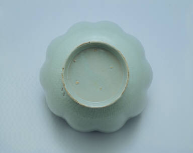 Warming bowl in the shaped of a flower with light bluish-green glaze