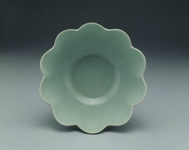 Warming bowl in the shaped of a flower with light bluish-green glaze