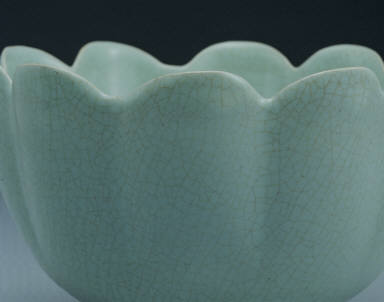 Warming bowl in the shaped of a flower with light bluish-green glaze