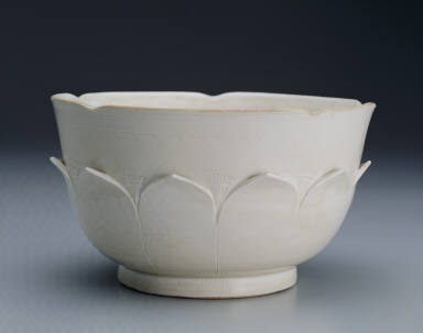 White glazed bowl with lotus petal decoration in relief and Guan mark