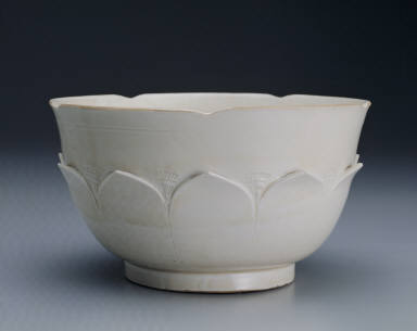 White glazed bowl with lotus petal decoration in relief and Guan mark