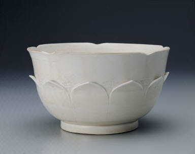 White glazed bowl with lotus petal decoration in relief and Guan mark