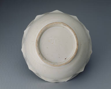 White glazed bowl with lotus petal decoration in relief and Guan mark