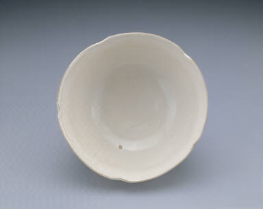 White glazed bowl with lotus petal decoration in relief and Guan mark