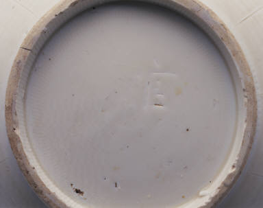 White glazed bowl with lotus petal decoration in relief and Guan mark