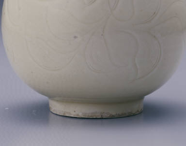 Long-necked vase with incised lotus design in white glaze