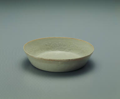 Pale bluish-green glazed bowl with impressed floral design