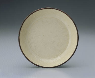 Dish impressed with design of playing lion in white glaze