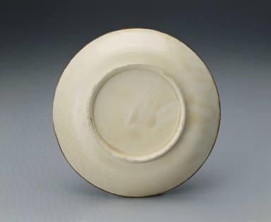 Dish impressed with design of playing lion in white glaze