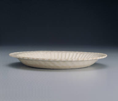 Dish with impressed design of peonies and pleated rim in white glaze