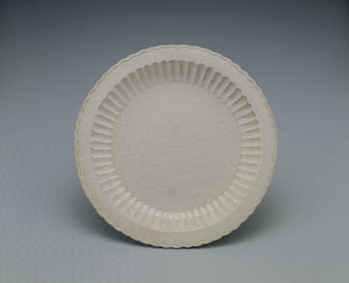 Dish with impressed design of peonies and pleated rim in white glaze