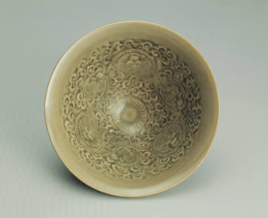 Bowl with impressed chrysanthemum design in yellowish-green glaze