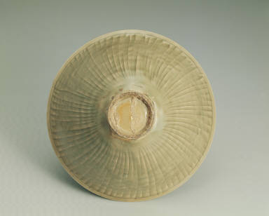 Bowl with impressed chrysanthemum design in yellowish-green glaze