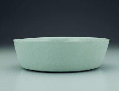 Basin with impressed dragon design in light bluish-green glaze
