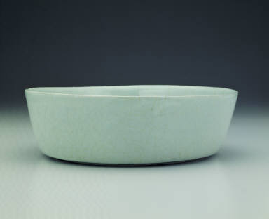 Basin with impressed dragon design in light bluish-green glaze