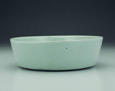 Basin with impressed dragon design in light bluish-green glaze