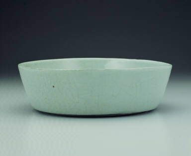 Basin with impressed dragon design in light bluish-green glaze