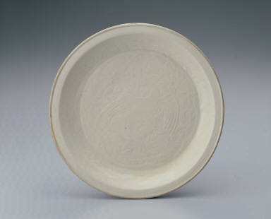 Plate with impressed design of a dancing phoenix in white glaze