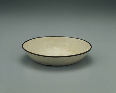 Dish with impressed motif of six chi dragons in white glaze