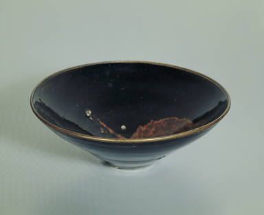 Black glazed bowl with leaf pattern