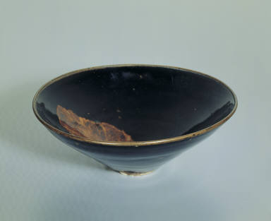 Black glazed bowl with leaf pattern