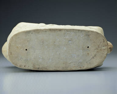 Pillow in the shape of a recumbent child with white glaze