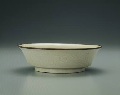 Bowl with incised lotus and chi-dragon design in white glaze
