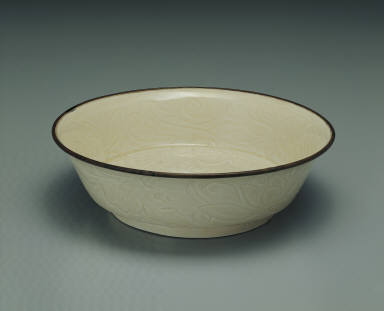 Bowl with incised lotus and chi-dragon design in white glaze