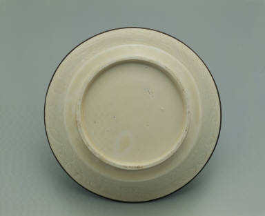 Bowl with incised lotus and chi-dragon design in white glaze
