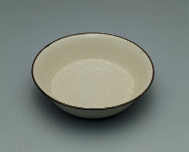 Bowl with incised lotus and chi-dragon design in white glaze