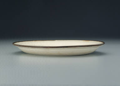 Dish with impressed scene of children at play in white glaze